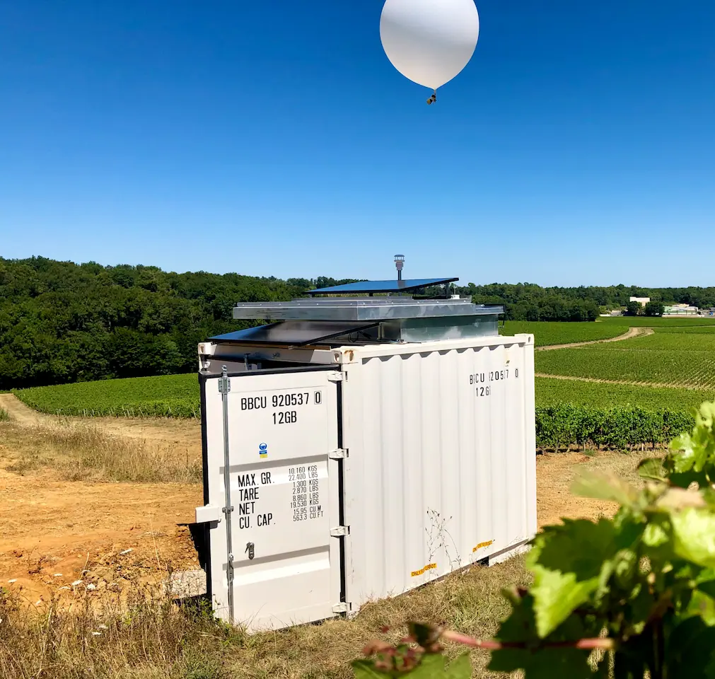 Selerys SOBLI cloud seeding balloon launcher releasing a balloon over a vineyard