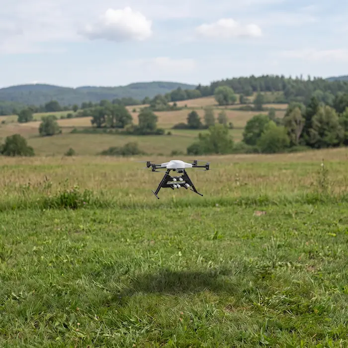 LAICO smart drone by SELERYS hovering over open grassland during a cloud seeding flight